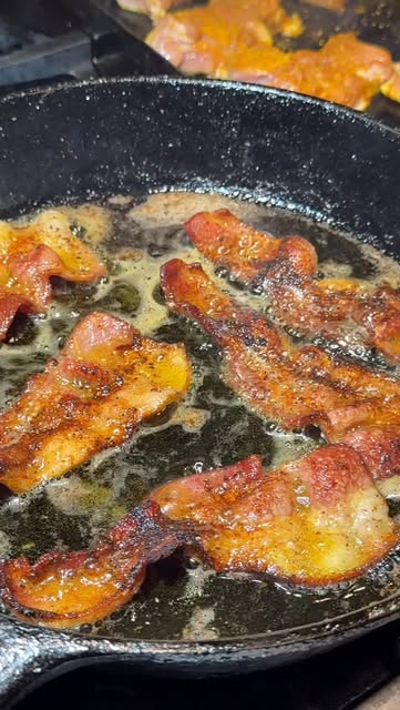 Seasoned bacon sizzling in a cast iron pan