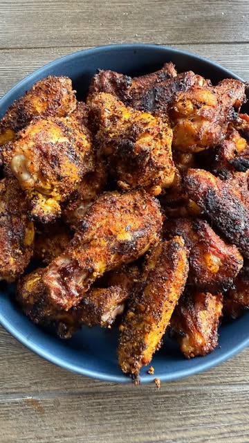A pile of crispy seasoned wings and drumsticks